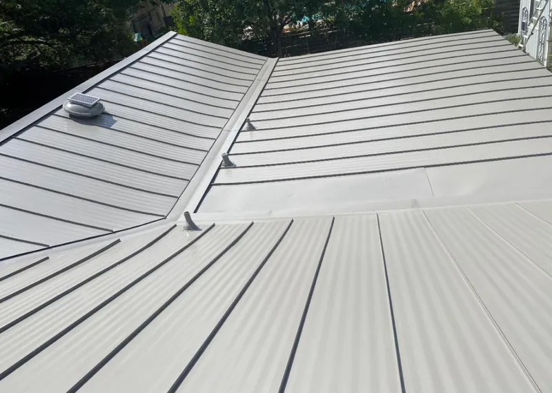 Solar attic fan installed on a metal roof for Roof Ventilation in Wharton